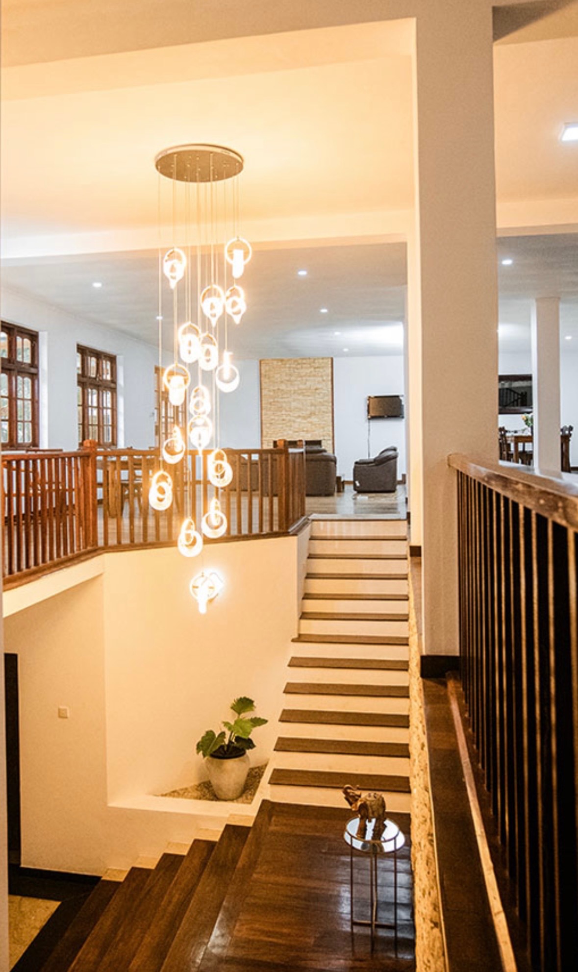 Grand entrance with crystal chandeliers and elegant dual staircase